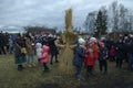 Crowd of people celebrating Masnytsya - pagan holiday of farewell to winter, preparing the straw scarecrow for burning