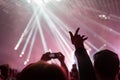 A crowd of people at the concert have fun and dance to the music at the concert. Pink light in background. The concept of Royalty Free Stock Photo