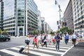 A crowd of people crossing a city street at the pedestrian crossing Royalty Free Stock Photo