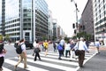 A crowd of people crossing a city street at the pedestrian crossing Royalty Free Stock Photo