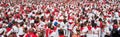 Crowd of people dressed in white and red at the Summer festival of Bayonne Fetes de Bayonne France