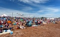 Crowd of people enjoying sun on sandy beach of British riviera in Paignton, Devon. Sunny summer day in popular seaside resort with