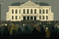 crowd of people in front of government building, demanding reform and change