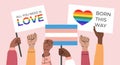 A crowd of people holding lgbtq posters and symbols, transgender and bisexual flag Royalty Free Stock Photo