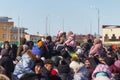 A crowd of people on a holiday watching a concert, children sit on the neck of their parents and watch a concert