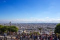 Crowd of people looking down the city of Paris from the summit of the butte Montmartre, the highest point in the city, nearby the