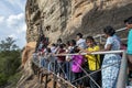 A crowd of people moving towards the frescoe cave on Sigiriya Rock in central Sri Lanka.