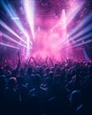 A crowd of people in a music event, dancing in neon pink color lights Royalty Free Stock Photo