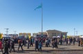 a crowd of people on Nazarbayev Square, the building of the Atameken Oner Ordasy art center is visible in the distance Royalty Free Stock Photo