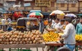 Crowd of people near Pineapple and orange marketplace at busy street farmers market