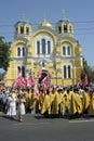 Crowd of people and orthodox priests in golden cassocks gathered in front of St Volodymyr's Cathedral. Ukrainian