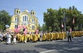 Crowd of people and orthodox priests in golden cassocks gathered in front of St Volodymyr's Cathedral. Ukrainian