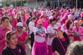 A crowd of people in pink costumes at a breast cancer awareness rally