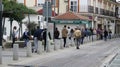 Crowd of people queuing outside bank on restricted opening day