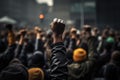 Crowd of people with raised hands at concert in the rain, A raised fist of a protestor at a political demonstration, AI Generated