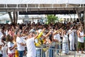 a crowd of people is raising hands at the beach area