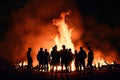 Crowd of people in silhouette watching easter fire or bonfire. Generative AI. Royalty Free Stock Photo