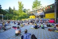 Crowd of people sitting on karemats at the open air cinema theater listening to the huru preaching