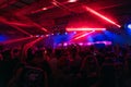 Crowd of people and stage lights at techno party