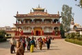 Crowd of people walk from the temple