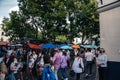 Crowd of people walking around a market square in Montmartre, Paris, France