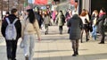 Warsaw, Poland. 8 March 2023. Crowd of people walking down an urban sidewalk Royalty Free Stock Photo