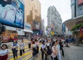 Crowd of people walking on street over zebra crossing or pedestrian crossing at shopping area with mall and department stores on Royalty Free Stock Photo