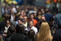 Crowd of people walking on street sidewalk