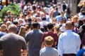 Crowd of people walking on street sidewalk