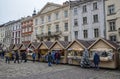 Crowd of people walking among Trade tents with Christmas gifts and souvenirsat the square