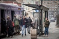 Crowd of persons, young & old, men and women, waiting a bus at a stop in Belgrade some wearing face mask,some not wearing facemas