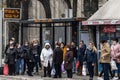 Crowd of persons, young and old, men and women, waiting a bus at a stop in Subotica wearing face mask protective equipement