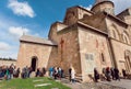 Crowd of praying men and women around the walls of Svetitskhoveli Cathedral. UNESCO World Heritage Site.