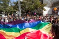 Crowd of protestors holding a giant rainbow gay flag during the 2017 Belgrade Gay Pride, happy and smiling