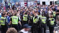 Crowd of rioters overtake group of policemen