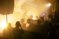 Crowd on the rock show. Silhouettes of people on the concert. Fans dancing and raising hands in front of the stage