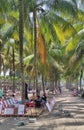 a crowd of salespeople under the shade of a coconut trees