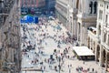 Crowd small figures of people on Piazza del Duomo square, Milan