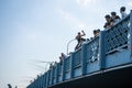 The crowd stands on the Galata Bridge and watches as people jump from the bridge into the water Royalty Free Stock Photo