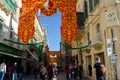 Crowd in street for Religious Feast of St Paul`s Shipwreck with colourful banners