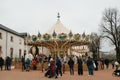 Crowd strolling near the carousel. La Roche Sur Yon, France