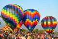 Three Colorful Hot Air balloons at a Festival
