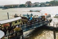 Crowd of Thai people passenger boats at Maharaj Pier to watch the royal procession transferring the body of the King