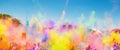 Crowd throwing bright colored powder paint in the air at Holi Festival Dahan