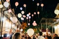 Crowd Throwing Colorful Balloons to Sky at night During Festival or wedding party