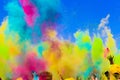 Crowd throws colored powder at holi festival Royalty Free Stock Photo