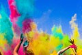 Crowd throws colored powder at holi festival Royalty Free Stock Photo