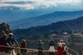 Crowd of tourists admiring Taormina aerial view from Greek amphitheater wall