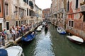 Crowd of tourists, floating motor boats and gondolas in Venice
