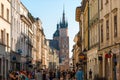 a crowd of tourists on Florian street, view of the Mariinsky church in the center of Krakow, Poland Royalty Free Stock Photo